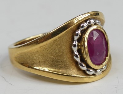 Lot 2685 - An 18ct gold ruby set heavy dress ring,...