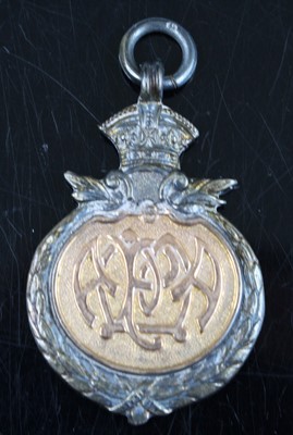 Lot 543 - A George V silver and yellow metal fob medal...