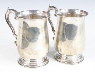 Lot 2212 - A pair of George V silver tankards, of lower...