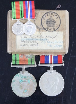 Lot 677 - A pair of WW II medals to include Defence and...