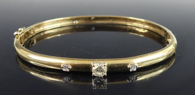 Lot 2536 - A modern 9ct gold diamond set hinged bangle,...