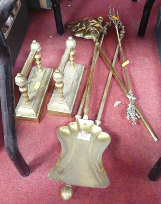 Lot 175 - A collection of brass fire tools, together...