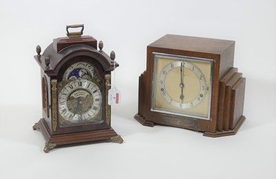 Lot 7 - An Art Deco oak cased mantel clock, having an...