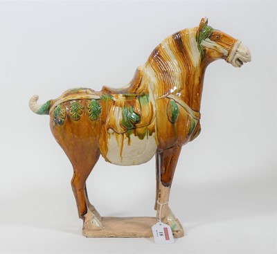 Lot 18 - A Chinese Tang style sancai funerary horse,...