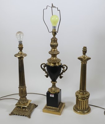 Lot 21 - A collection of three brass table lamps, the...