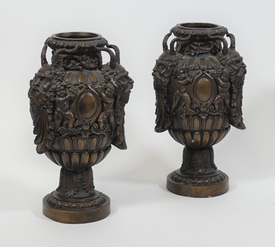 Lot 46 - A pair of bronze urns, each decorated with...