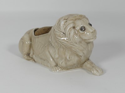 Lot 233 - A porcelain pin cushion in the form of a lion,...