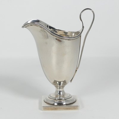 Lot 266 - An Edward VII silver milk jug, of helmet shape,...