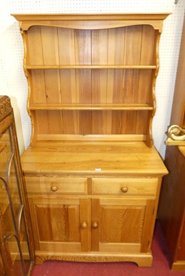 Lot 1117 - A small modern stained pine kitchen dresser,...