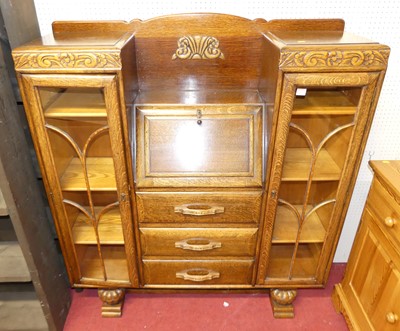 Lot 1119 - A 1930s moulded oak combination...