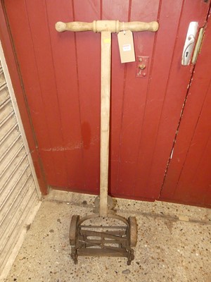 Lot 1134 - A vintage wrought iron and turned wood push mower