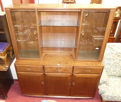 Lot 1137 - A contemporary Ercol mid-elm wall unit, having...