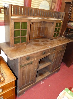 Lot 1140 - An Arts & Crafts oak squat dresser, the upper...