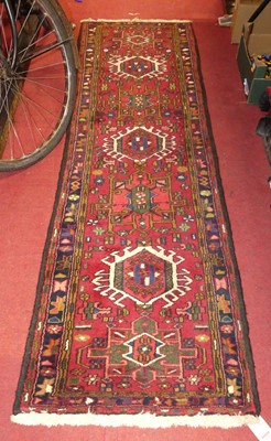 Lot 1149 - A Turkish woollen red ground hall runner, 206...