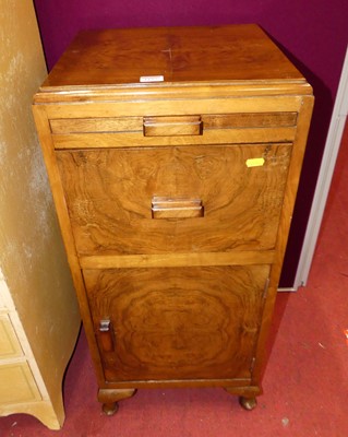 Lot 1157 - A 1930s figured walnut bedside cupboard, with...