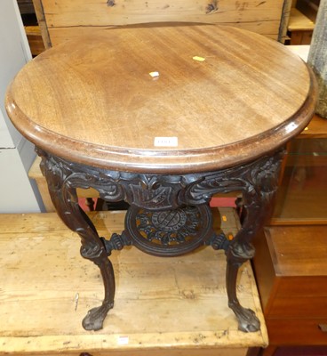 Lot 1184 - A cast iron based and mahogany topped circular...