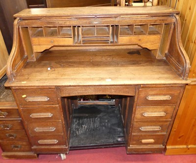 Lot 1205 - A 1930s oak rolltop kneehole desk, w.121cm