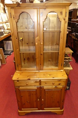 Lot 1206 - A modern pine round cornered bookcase cupboard,...