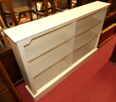 Lot 1215 - A cream painted dwarf open bookcase, having...