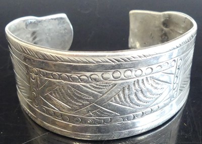 Lot 390 - A white metal engraved cuff bangle, valued as...