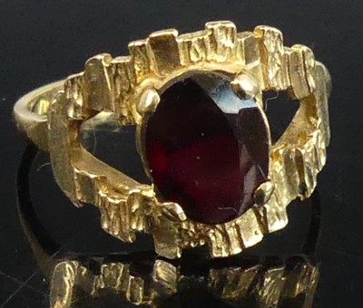 Lot 403 - A modern 9ct gold garnet set dress ring, the...