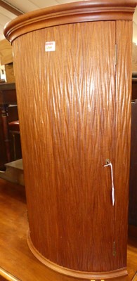 Lot 1198 - A contemporary bow front single door hanging...