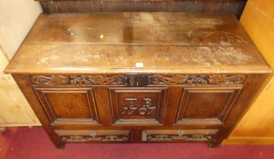 Lot 1265 - An C18th  joined oak three-panelled hinge top...