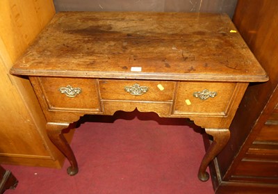 Lot 1269 - A 19th century oak three-drawer low boy,...