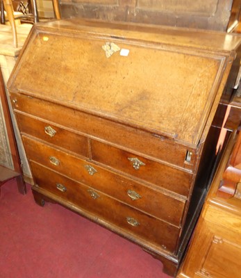 Lot 1281 - A George III oak slopefront writing bureau,...