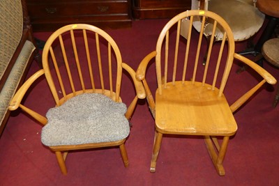 Lot 1344 - An Ercol blond elm stickback rocking elbow...