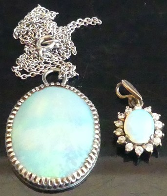 Lot 447 - An opal pendant in white metal mount,...