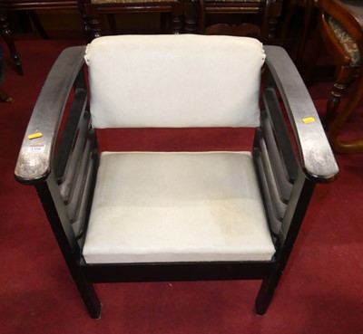 Lot 1354 - An ebonised and slatted elbow chair, with pale...