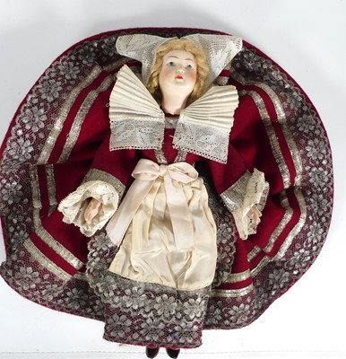 Lot 578 - A vintage plastic doll, wearing a silver...