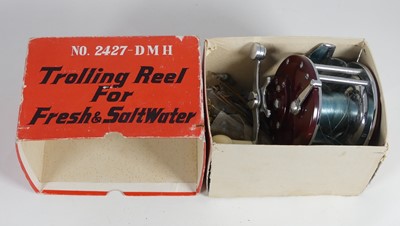 Lot 607 - A vintage trolling reel, together with a rod (2)