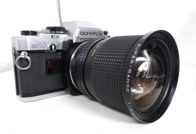 Lot 619 - A vintage Olympus OM10 SLR camera, cased with...