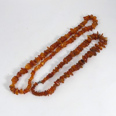 Lot 380 - A simulated amber single string bead necklace,...