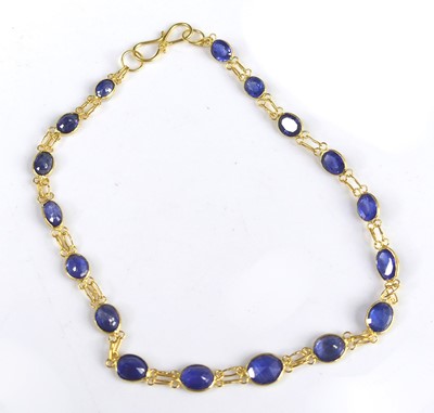 Lot 2764 - A 14ct gold and blue sapphire bracelet,...