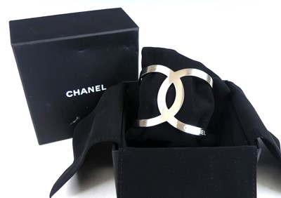 Lot 2709 - A Chanel-CC logo open cut-out B17V cuff bangle,...