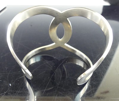 Lot 2709 - A Chanel-CC logo open cut-out B17V cuff bangle,...