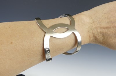Lot 2709 - A Chanel-CC logo open cut-out B17V cuff bangle,...
