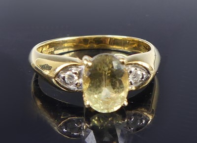 Lot 2653 - An 18ct gold peridot and diamond three-stone...