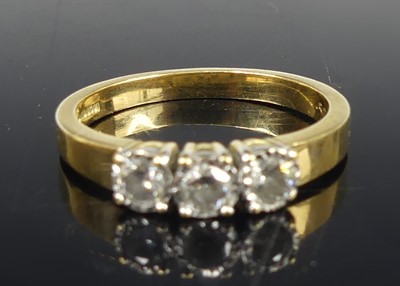 Lot 2655 - An 18ct gold diamond three-stone ring,...