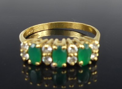 Lot 2712 - An 18ct gold, emerald and diamond half-hoop...