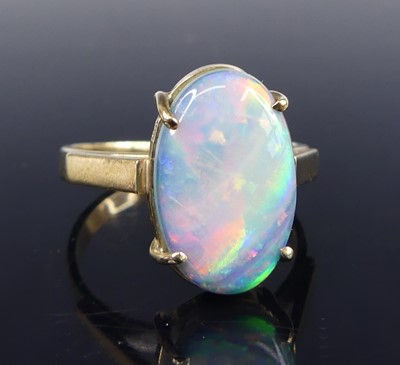 Lot 2714 - A 9ct gold opal dress ring, the four-claw set...