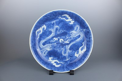 Lot 16 - A large Chinese blue and white “dragon” dish,...