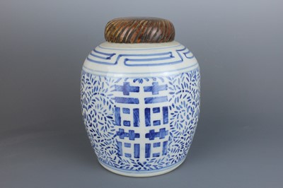 Lot 22 - A Chinese blue and white ovoid jar with wooden...