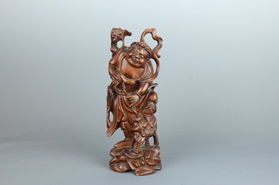 Lot 34 - A Chinese hardwood carving of an immortal...