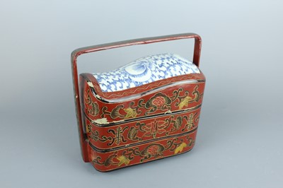 Lot 42 - A Chinese lacquered food box with porcelain...