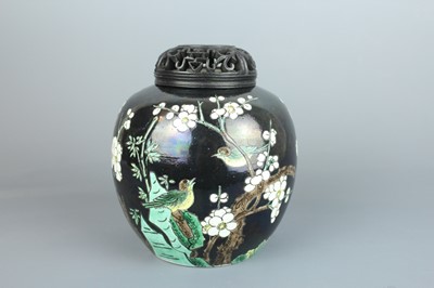 Lot 67 - A Chinese famille noire ovoid jar and wooden...