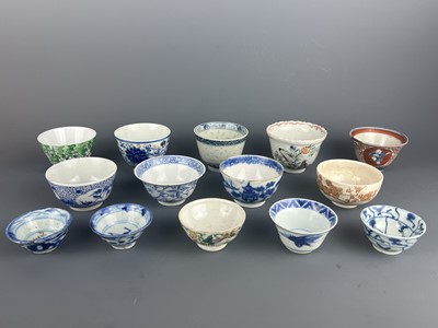 Lot 108 - A set of fourteen Chinese and Japanese cups,...